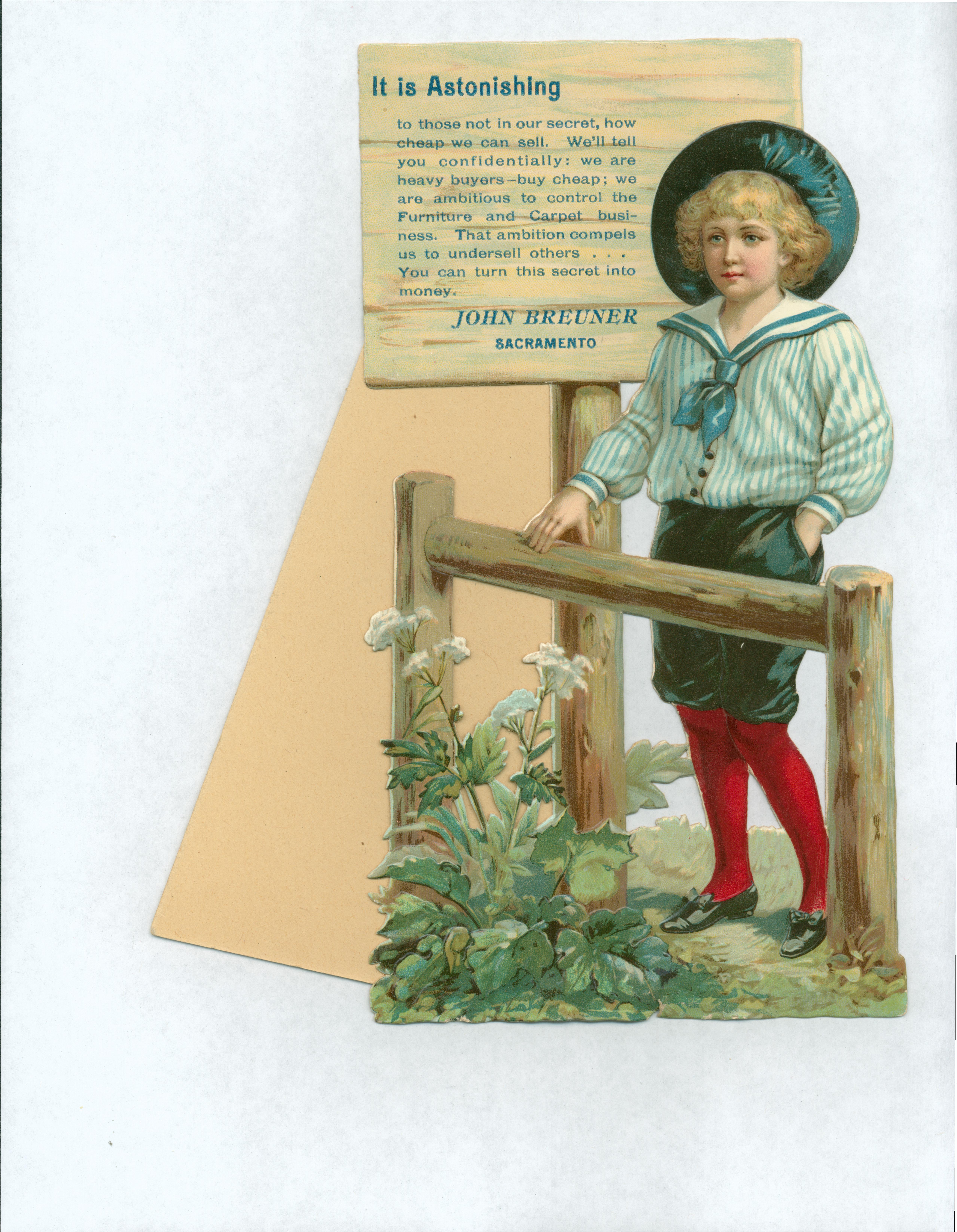 Standable card with figure of boy in middy shirt, shorts and long socks standing next to a fence